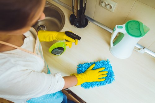 Cleaner maintaining a neat living space during a regular visit in Edgware