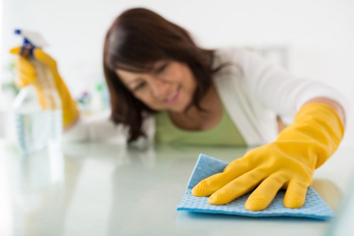 Cleaner treating a carpet stain with specialist equipment