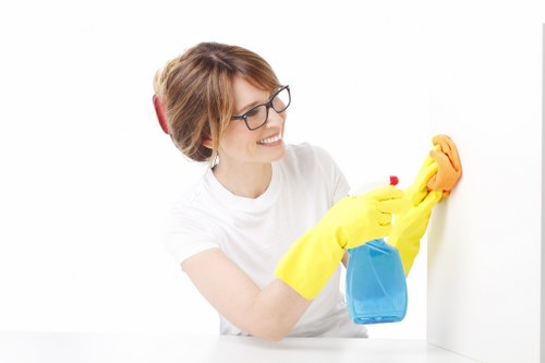 Cleaner working on windows at a local Edgware property